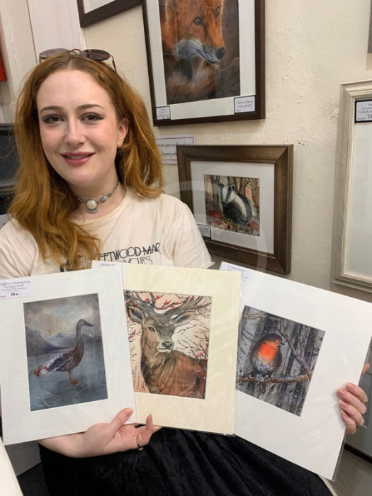 Artist Daisy with a selection of her artwork 